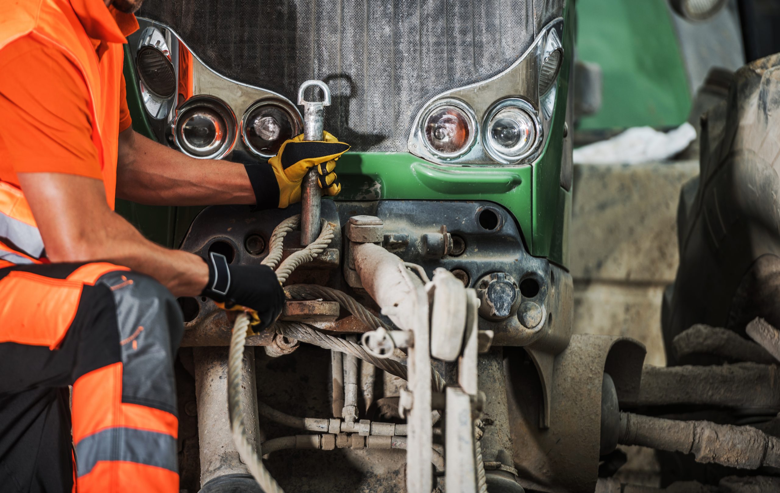 mechanic works on truck in repair shop during day